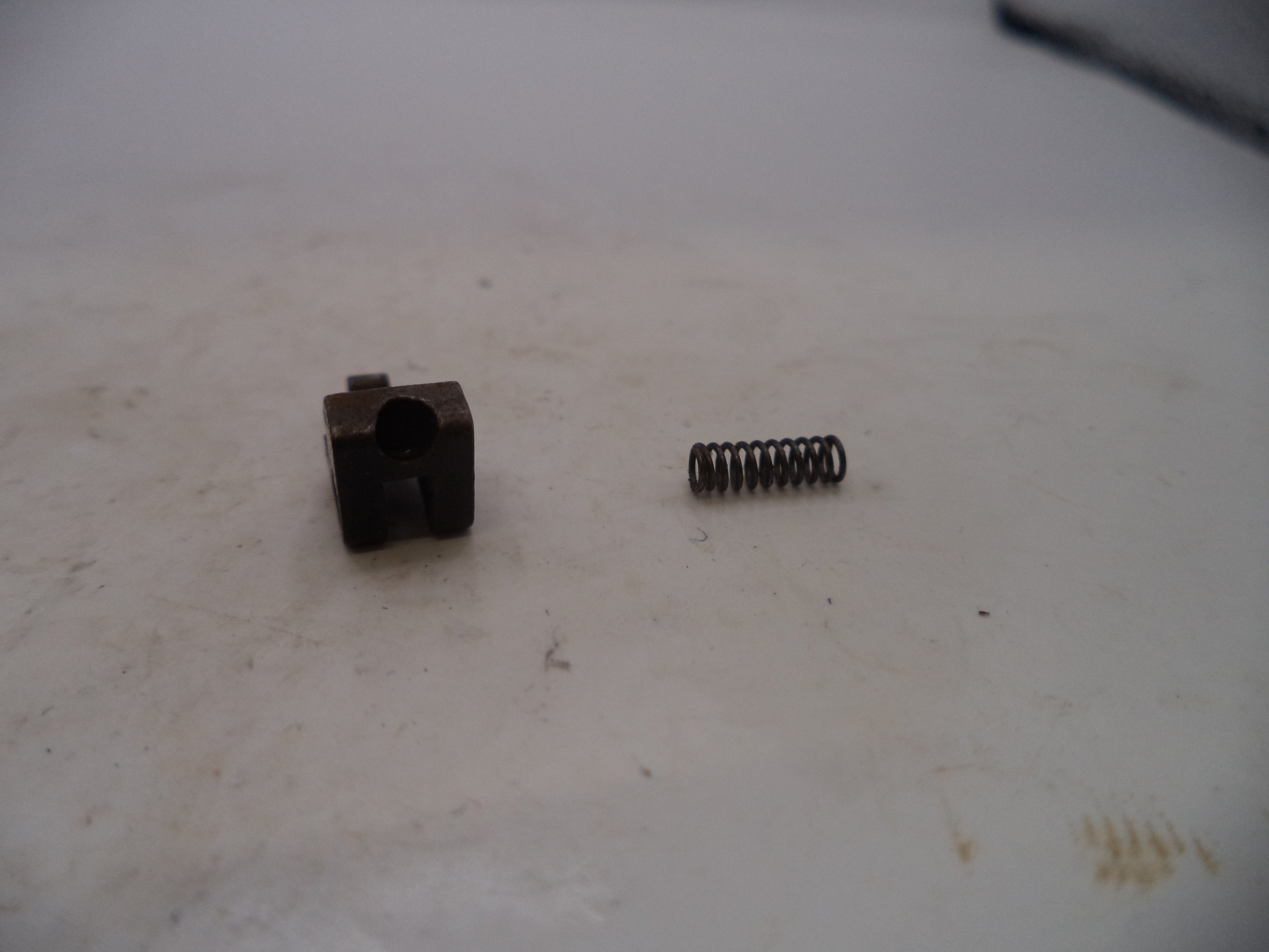 Small metal component and spring on a worn surface