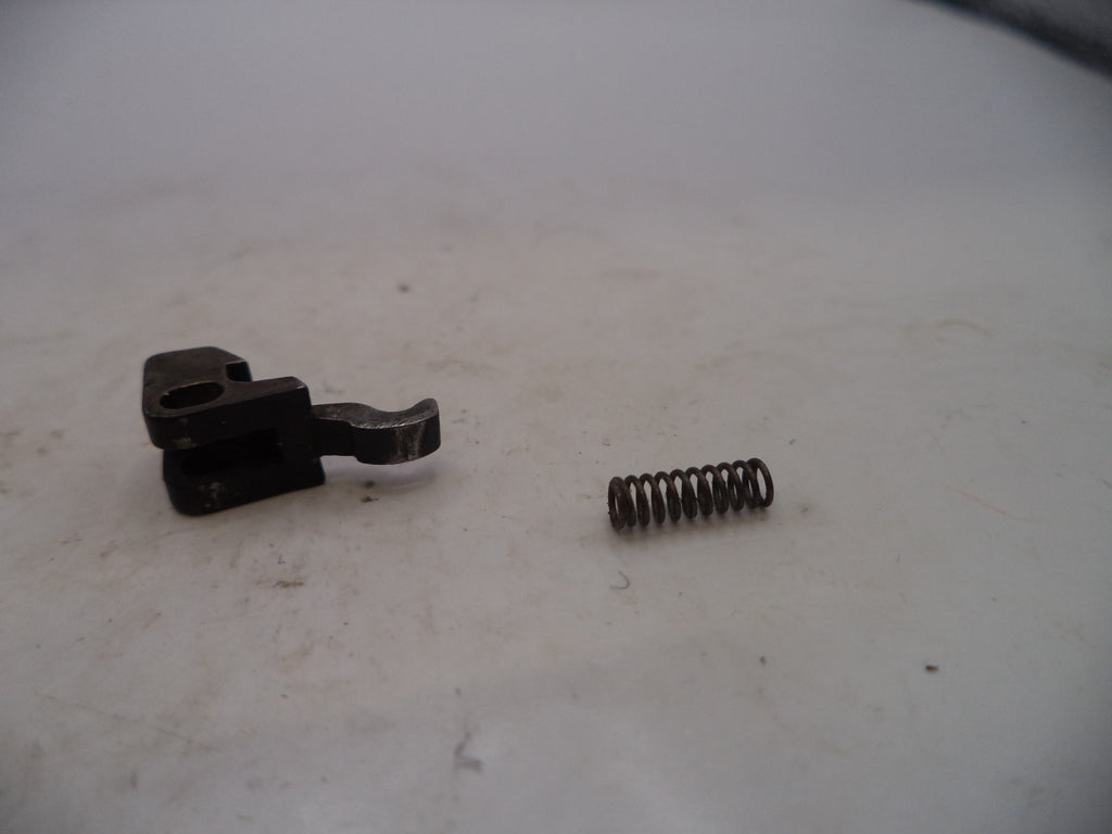 Mechanical component and spring on a white surface