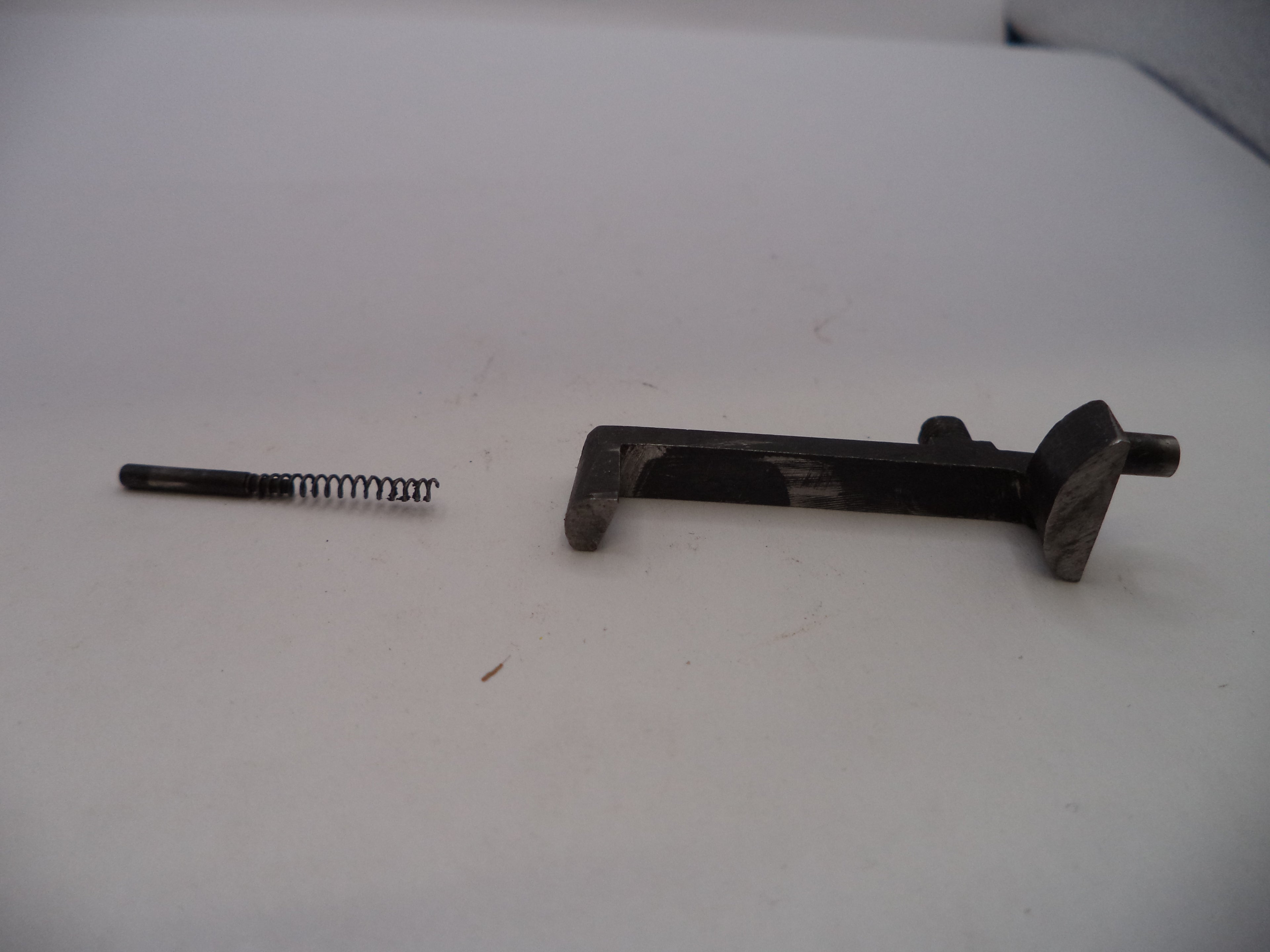 Two metal components on a white surface
