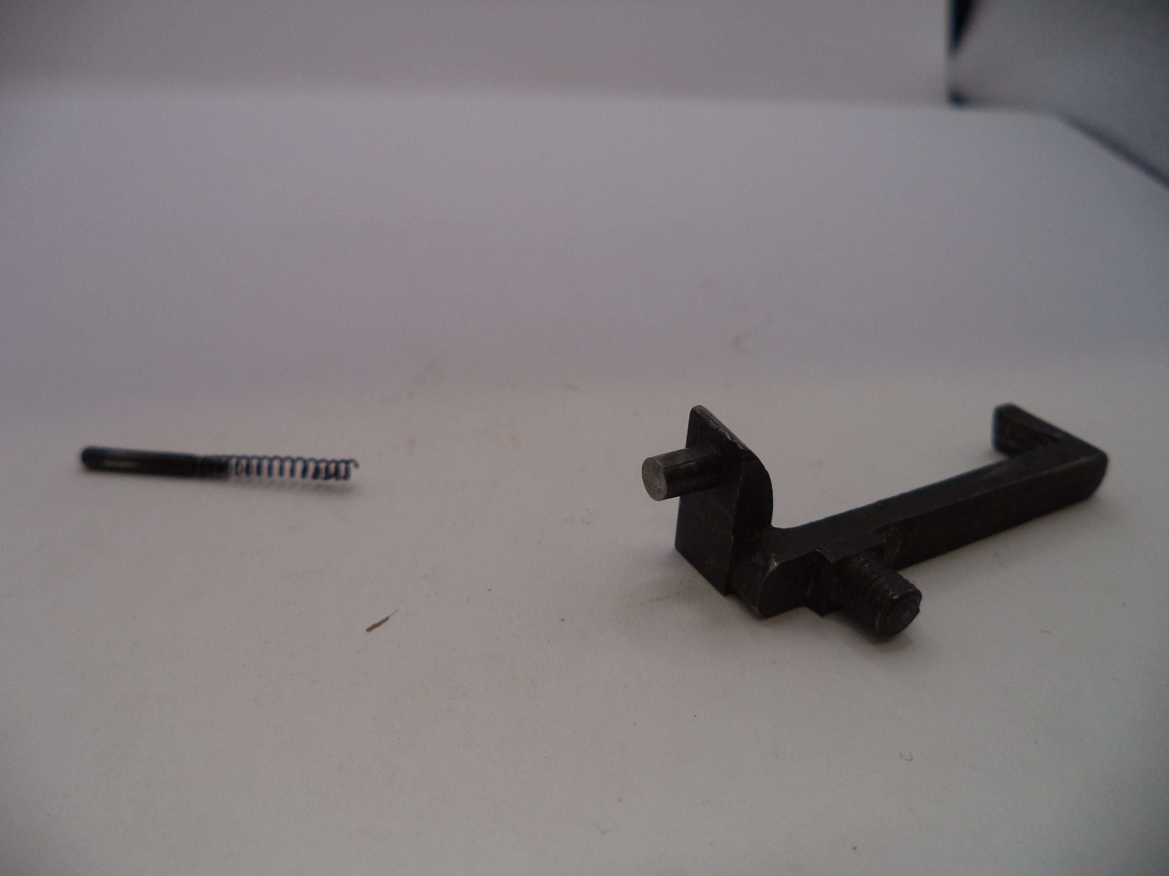 Two black metal components on a white surface