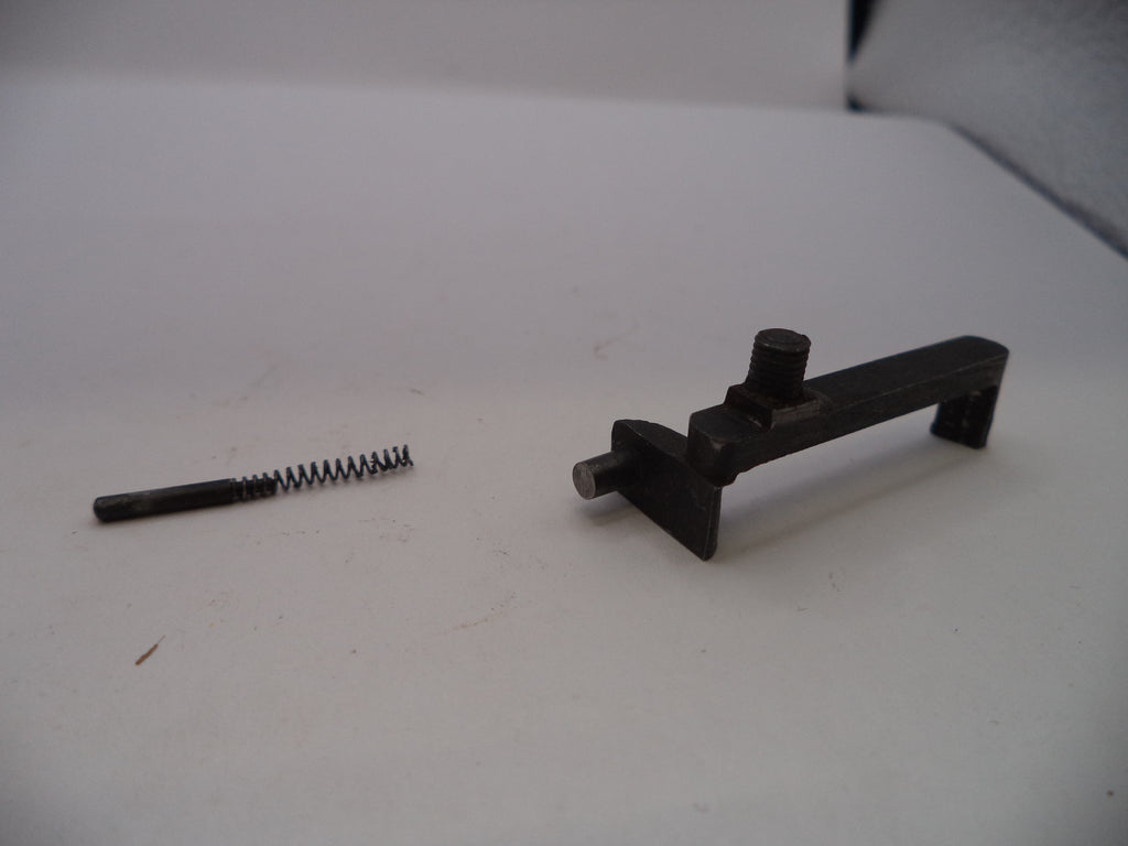 Two black metal components on a white surface