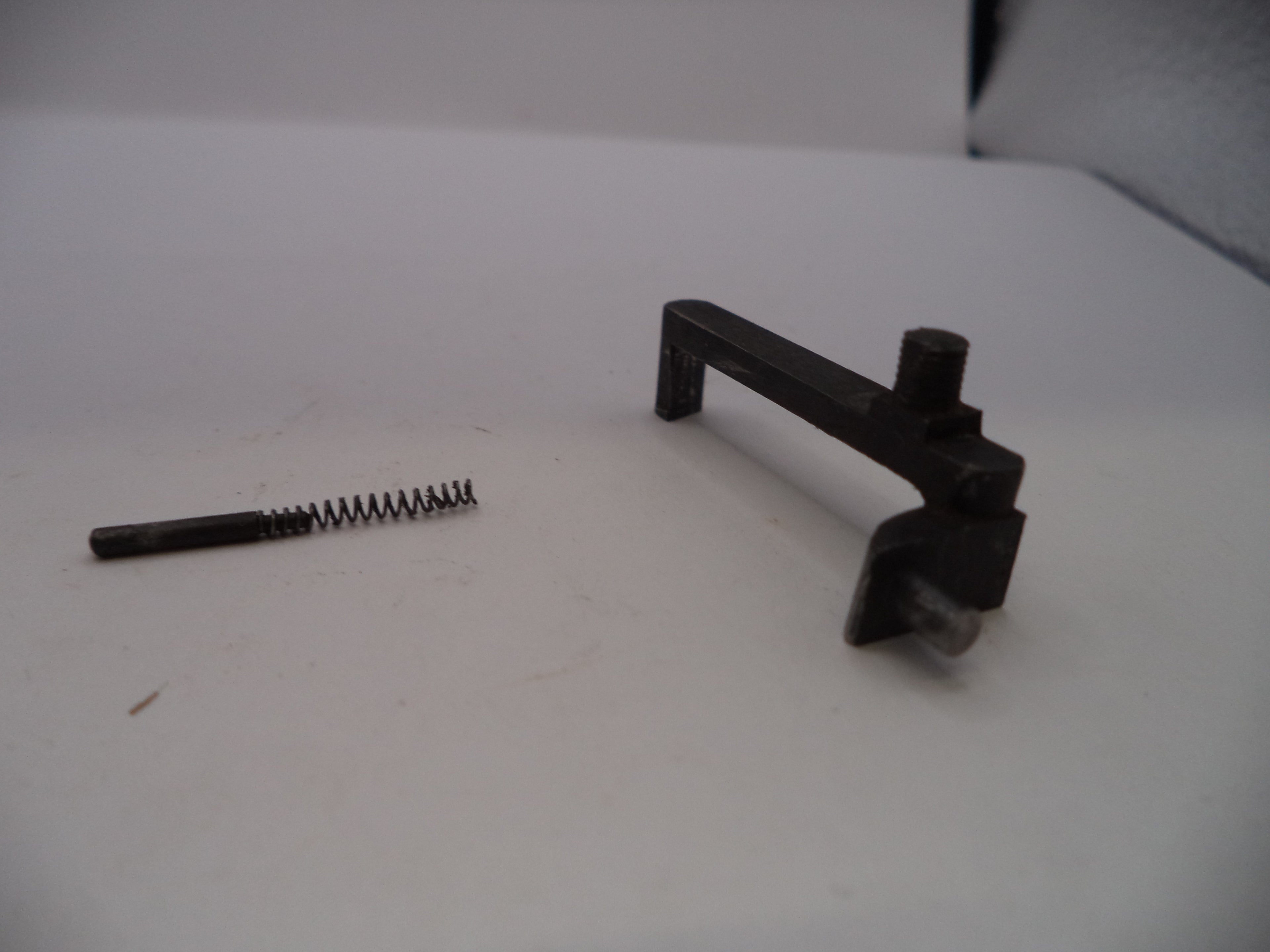Two metal components on a white surface