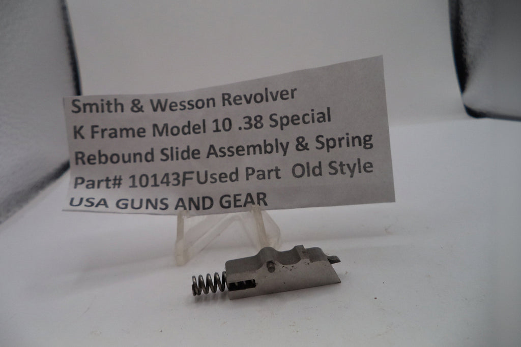 Smith & Wesson revolver part with a label on a white background