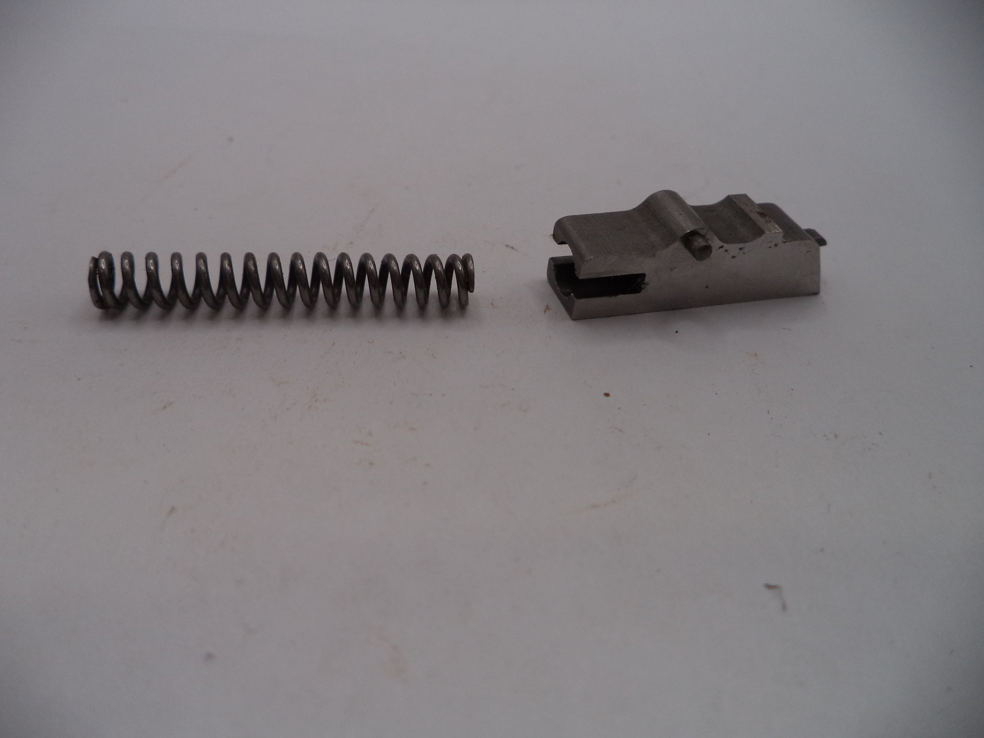 Metal spring and metal component on a white background