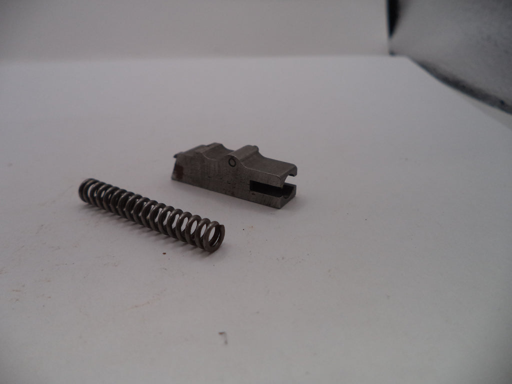 Metal spring and component on a white surface