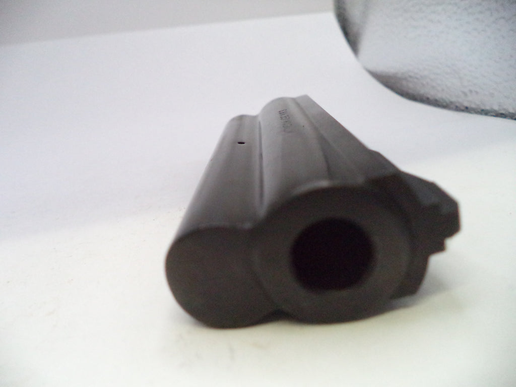 A close-up shot of a black plastic cylindrical component, possibly a grip or barrel tip, on a white surface.