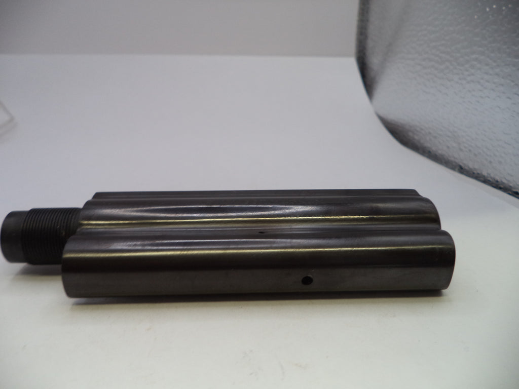 A dark metallic cylindrical mechanical part with a threaded black end, resting on a white surface.