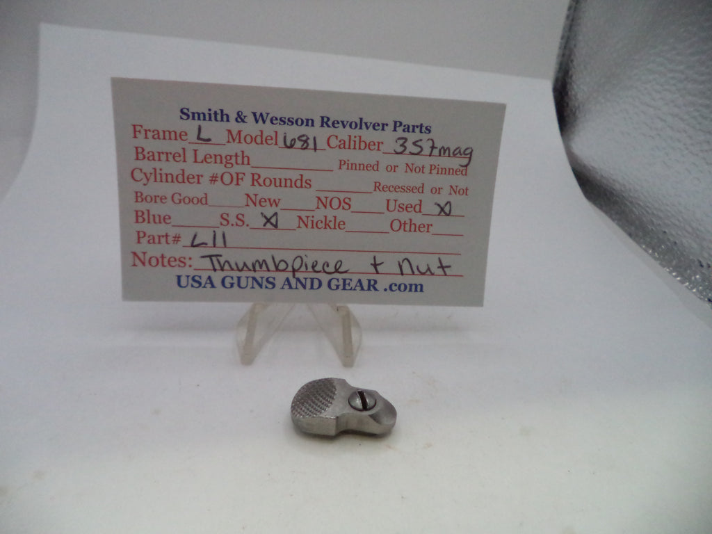 A small metallic revolver part displayed on a clear stand in front of a printed parts information card for Smith & Wesson revolvers, on a white surface.