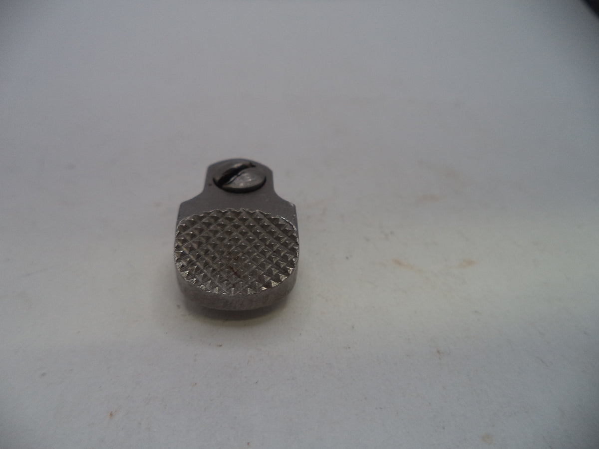 A small metallic silver screw cap with a textured knurled grip on a plain off-white background.