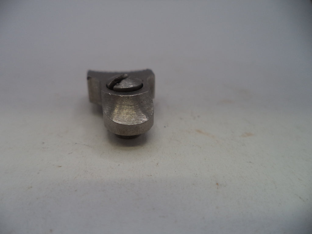 A small metallic mechanical part, possibly a pinion gear or bearing, shown on a plain off-white surface.