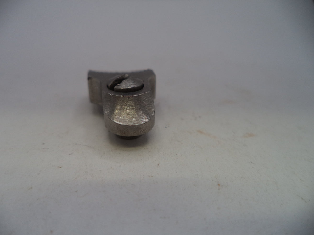 A small metallic mechanical part, possibly a pinion gear or bearing, shown on a plain off-white surface.