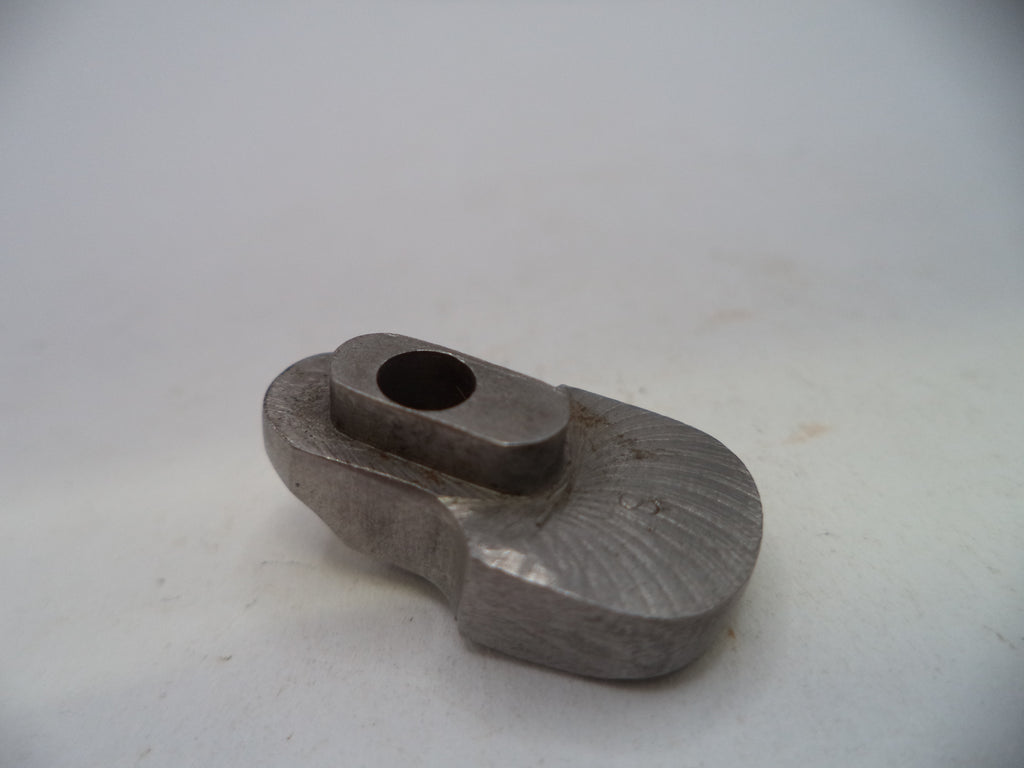 A small metallic gray tool or hardware piece with a circular opening, photographed on a plain light background.