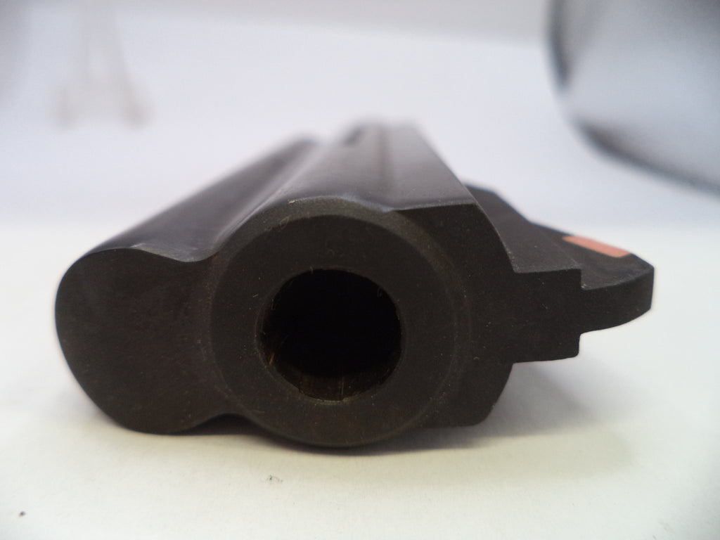 A close-up shot of a black plastic or rubber cylindrical component with a circular opening, photographed on a white surface with a blurred background.