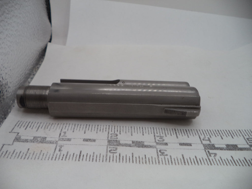 A metallic cylindrical tool or hardware piece with a threaded end, photographed on a white surface with a printed ruler for scale.