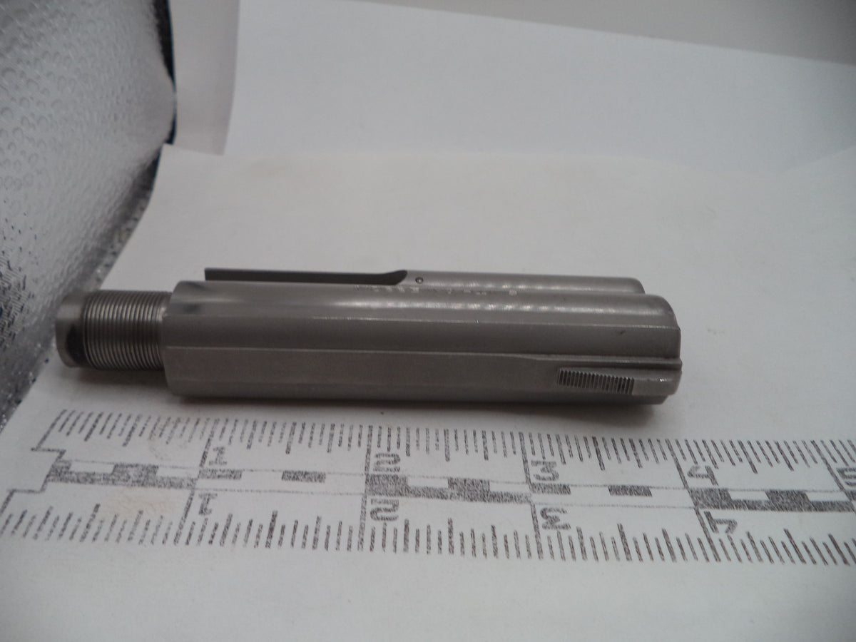 A metallic cylindrical tool or hardware piece with a threaded end, photographed on a white surface with a printed ruler for scale.