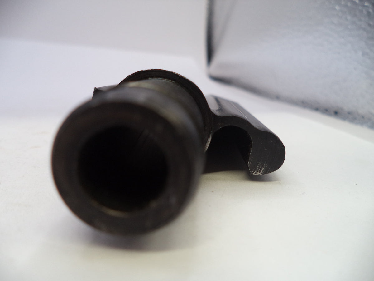 A close-up shot of a black plastic cylindrical component with a curved side tab, resting on a white surface.