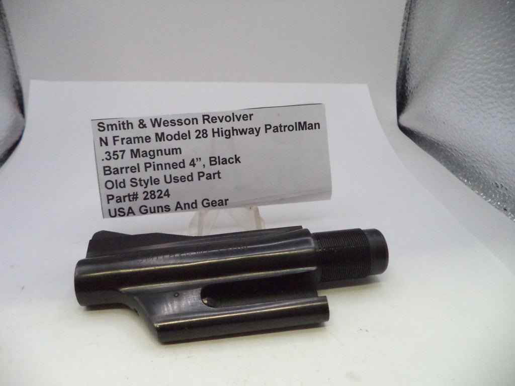 A black metal barrel pinning component for a Smith & Wesson revolver, displayed on a white surface with a product information card in the background.