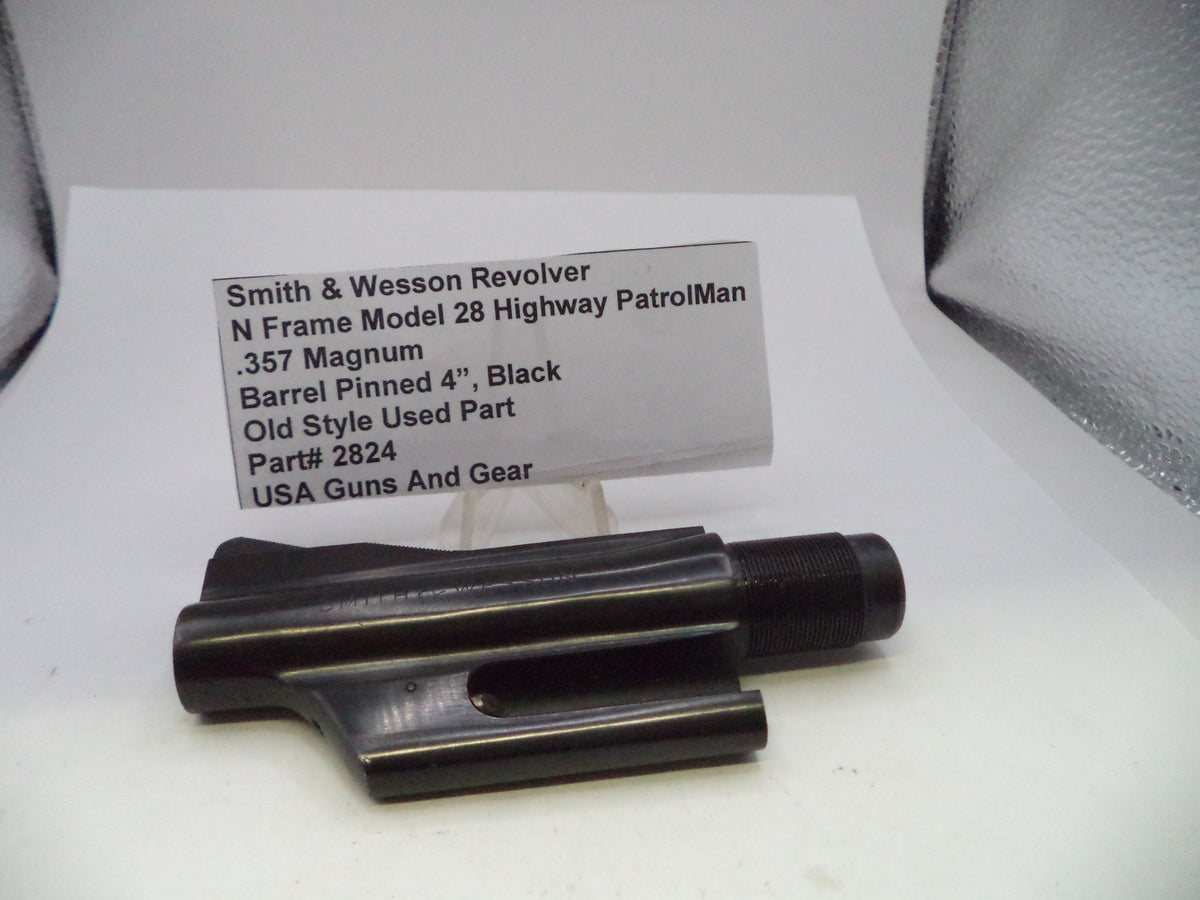A black metal barrel pinning component for a Smith & Wesson revolver, displayed on a white surface with a product information card in the background.