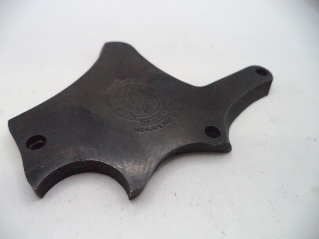 A dark metal replacement part with a curved, multi-pronged shape and two screw holes, featuring an embossed circular logo in the center, shown on a plain white background.