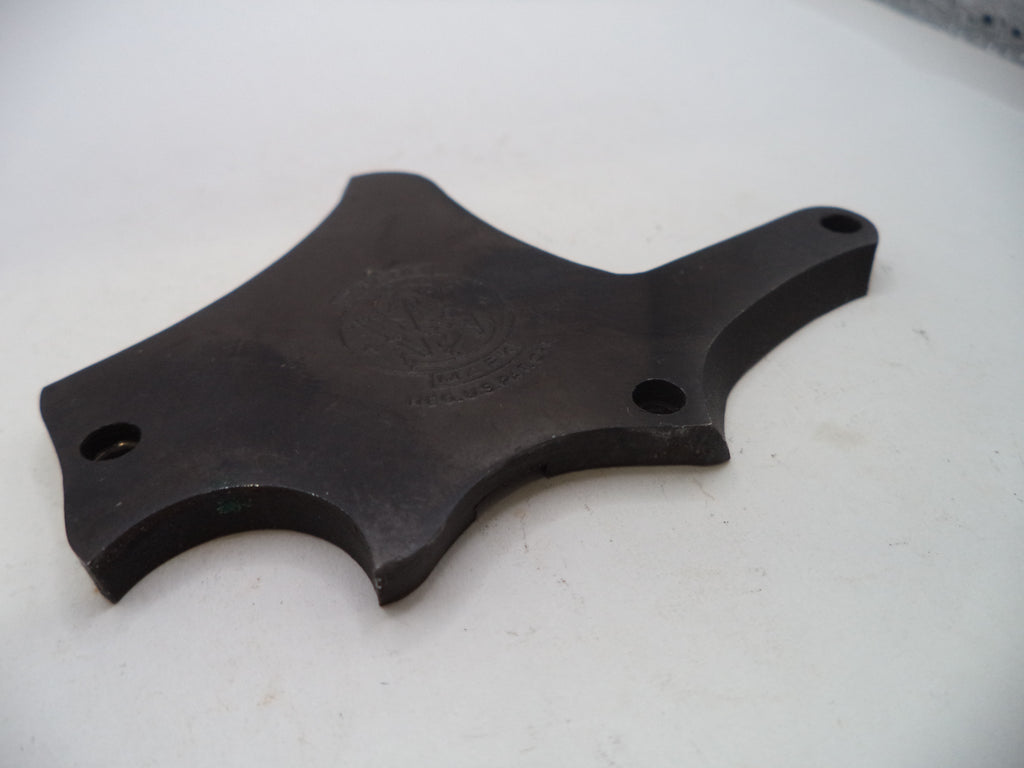 A dark gray cast metal mounting bracket with four pre-drilled holes, photographed on a white surface.
