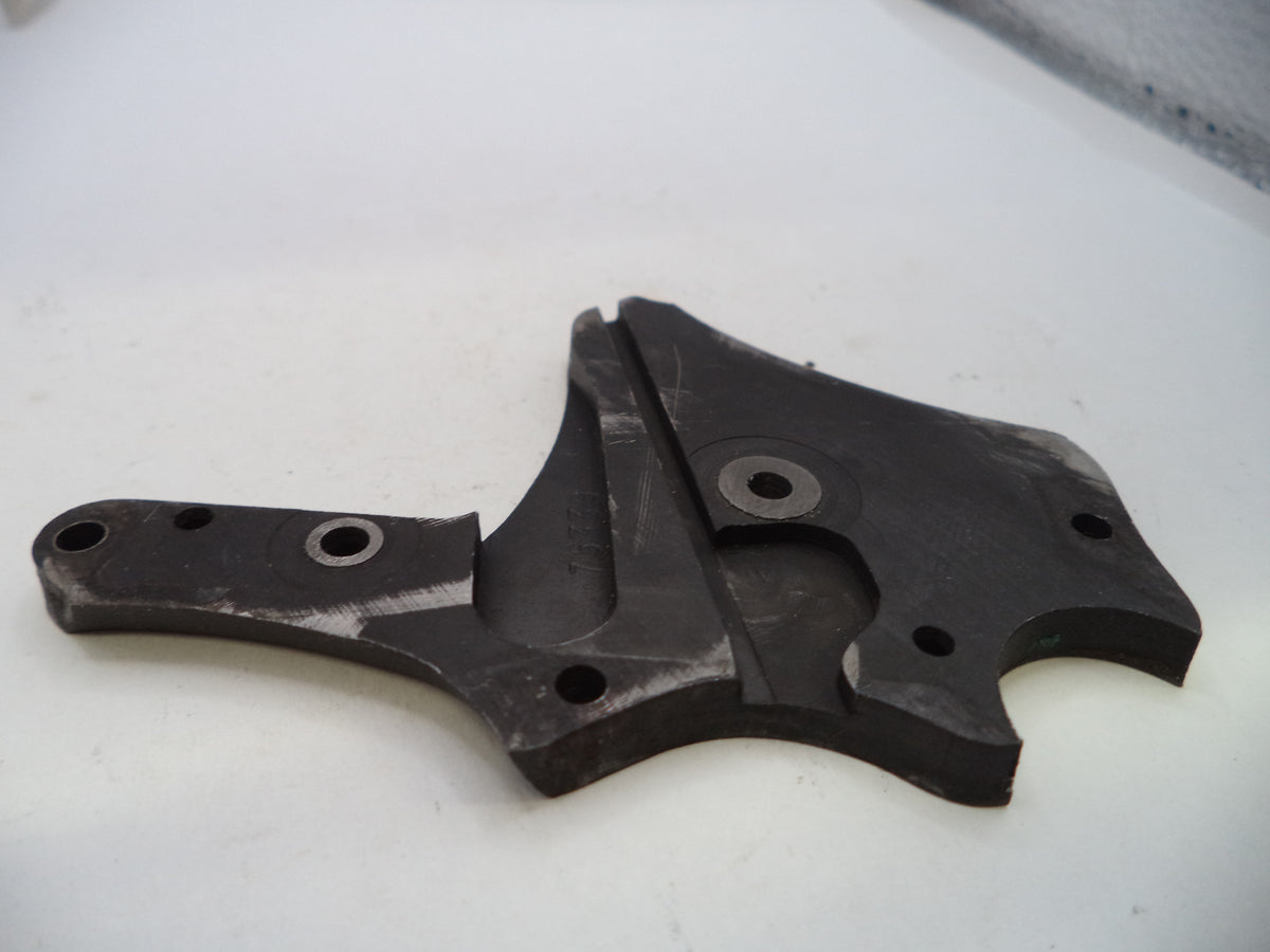 A dark gray or black molded plastic mechanical part with multiple pre-drilled holes, photographed on a plain white surface.