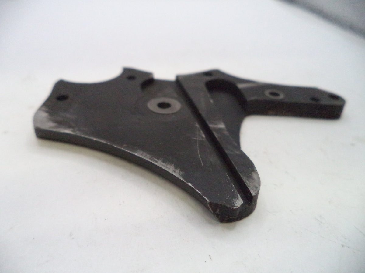 A black metal mechanical bracket or plate with pre-drilled holes and a central slot, photographed on a white surface.