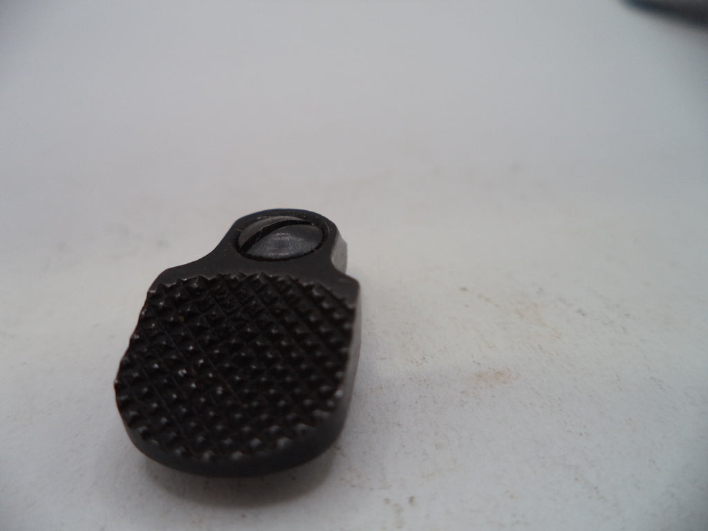 A close-up of a black textured plastic or rubber component with a circular opening, resting on a light off-white surface.