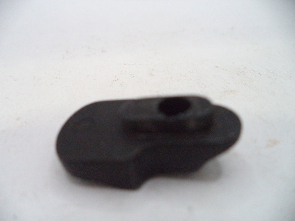 A small black plastic or rubber component with a central hole, photographed on a plain off-white background.