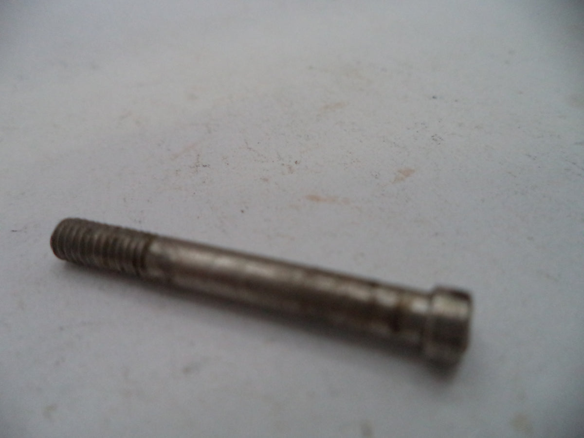 A small metal threaded bolt or pin with a hex head, shown on a plain off-white surface.