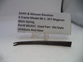 Smith & Wesson revolver main spring with a label on a white background