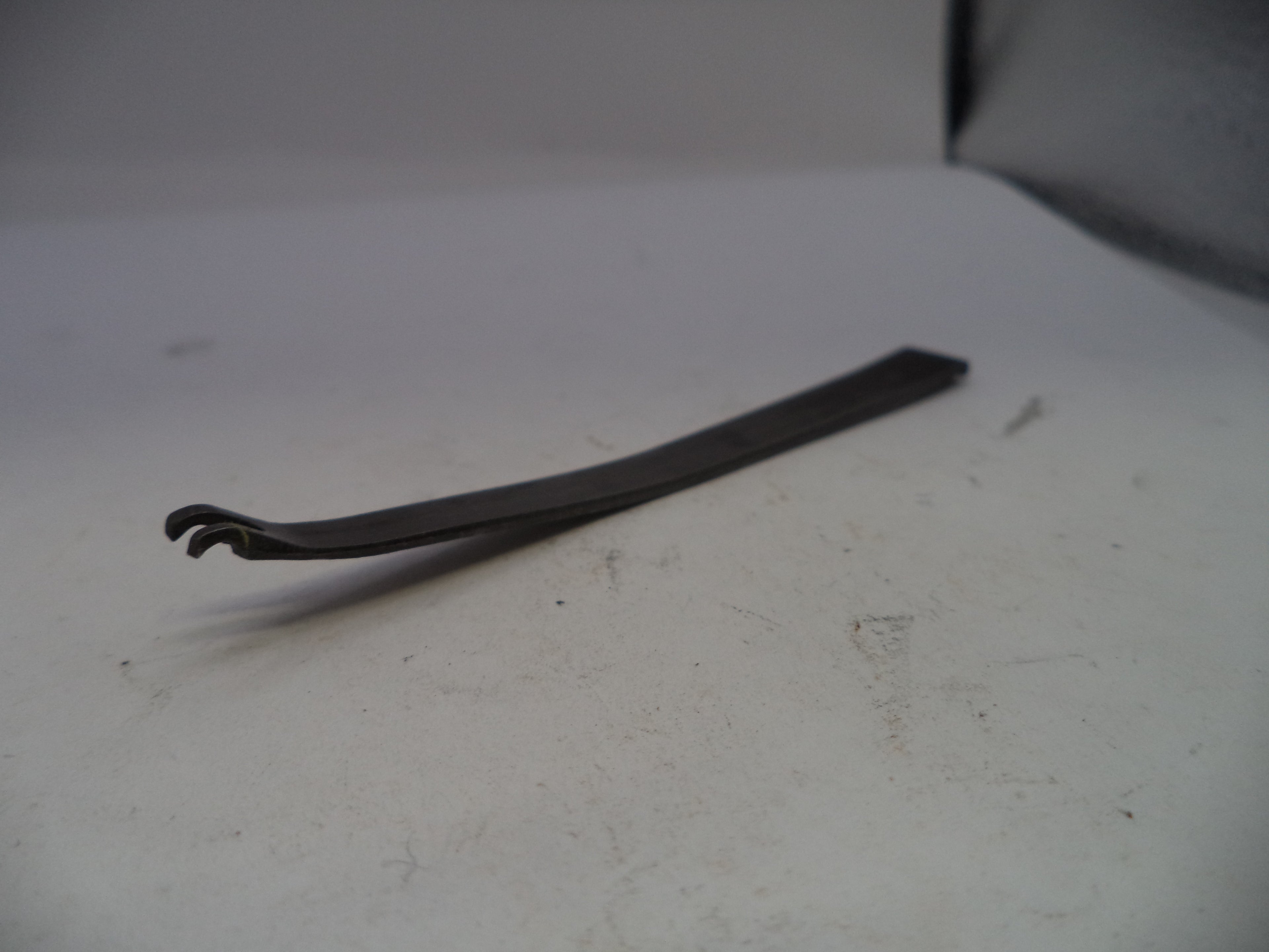 Metal tool on a white surface