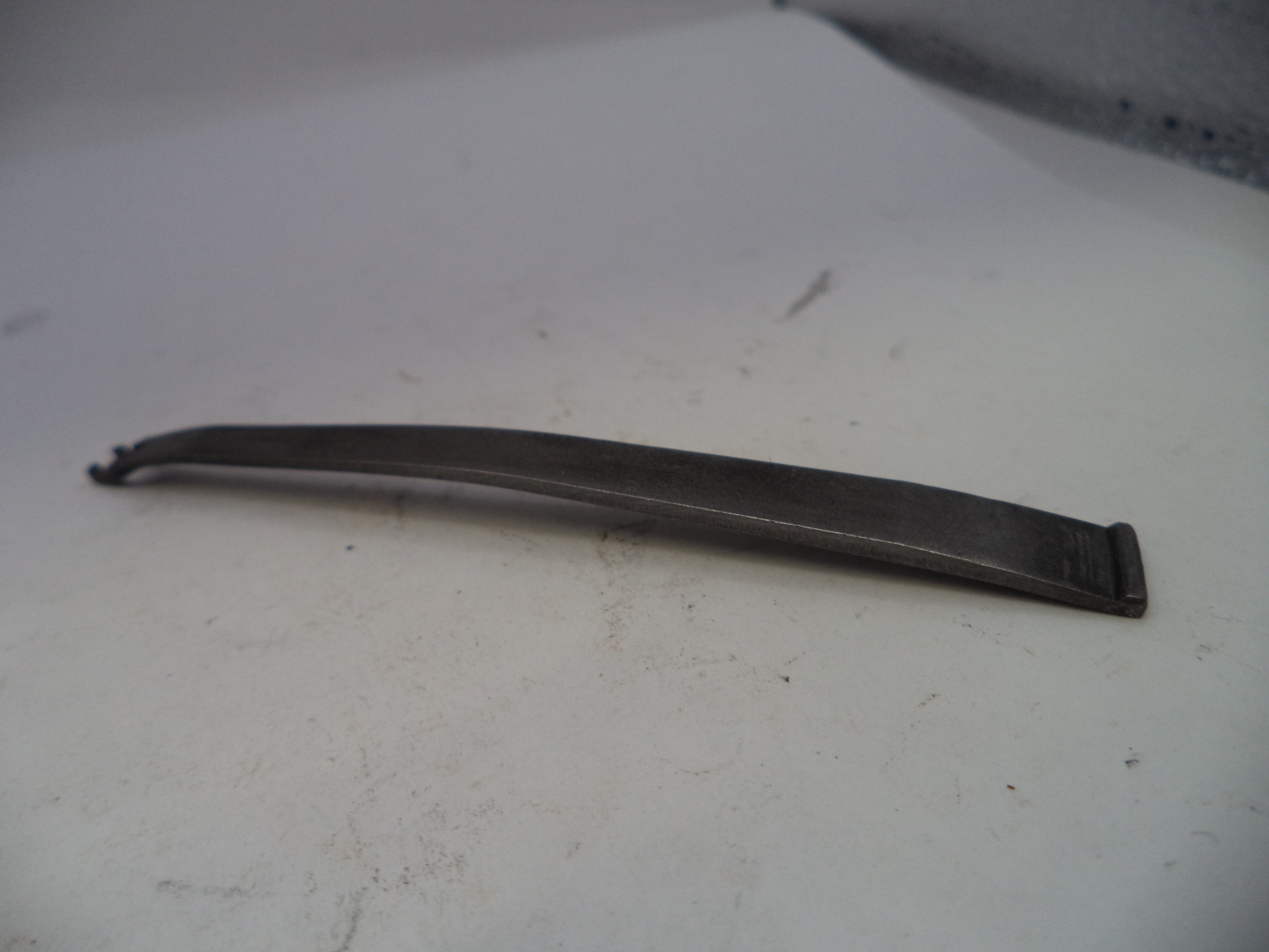 Metallic object on a white surface