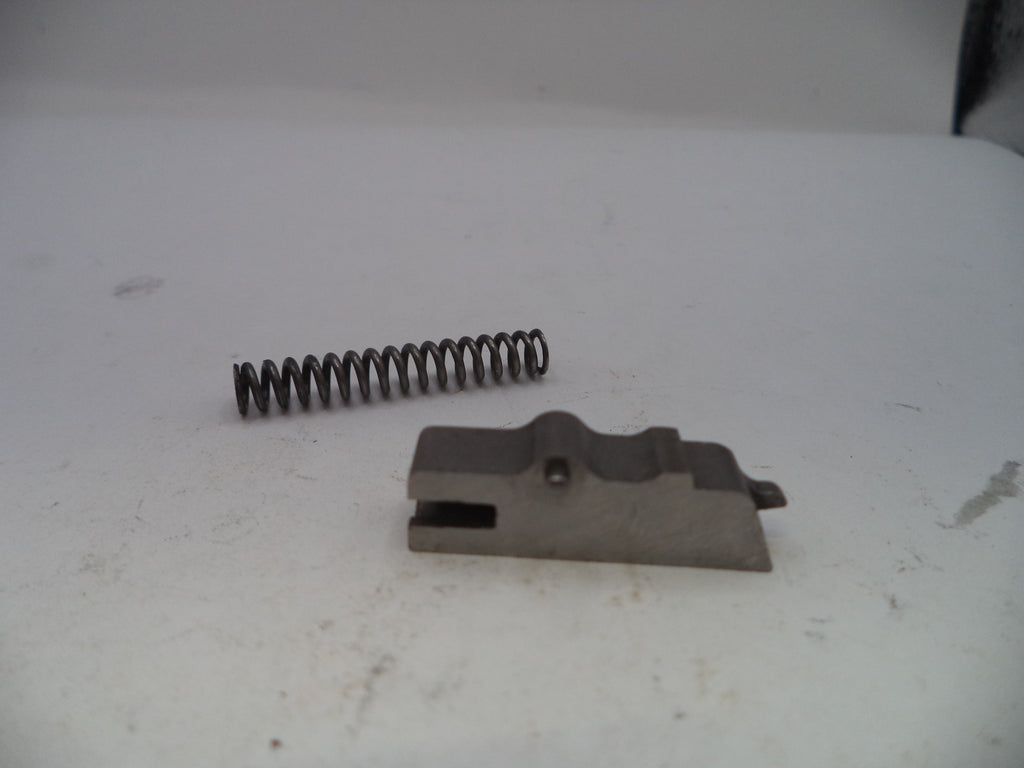 Metal spring and metal component on a white surface