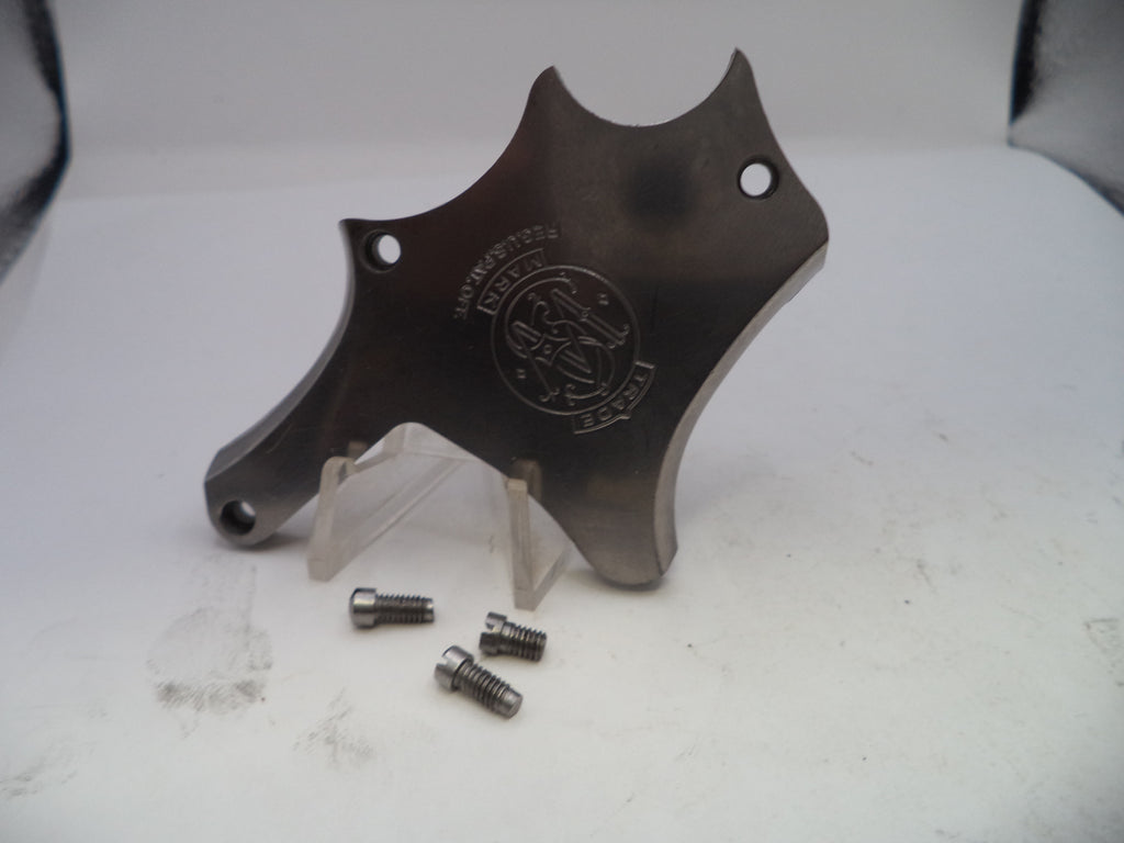 Metallic object with engraved logo on a white surface