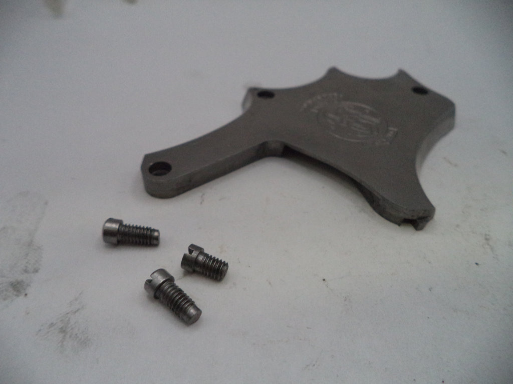 Metal component with screws on a white surface