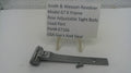 A metal Smith & Wesson revolver sight body part for Model 67 K, displayed on a white surface with a small white label card behind it that reads 'Smith & Wesson Revolver Model 67 K Frame Rear Adjustable Sight Body Used Part Part# 67166 USA Gurs And Gear'.
