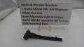 Smith & Wesson revolver part on a white surface with a descriptive sign.