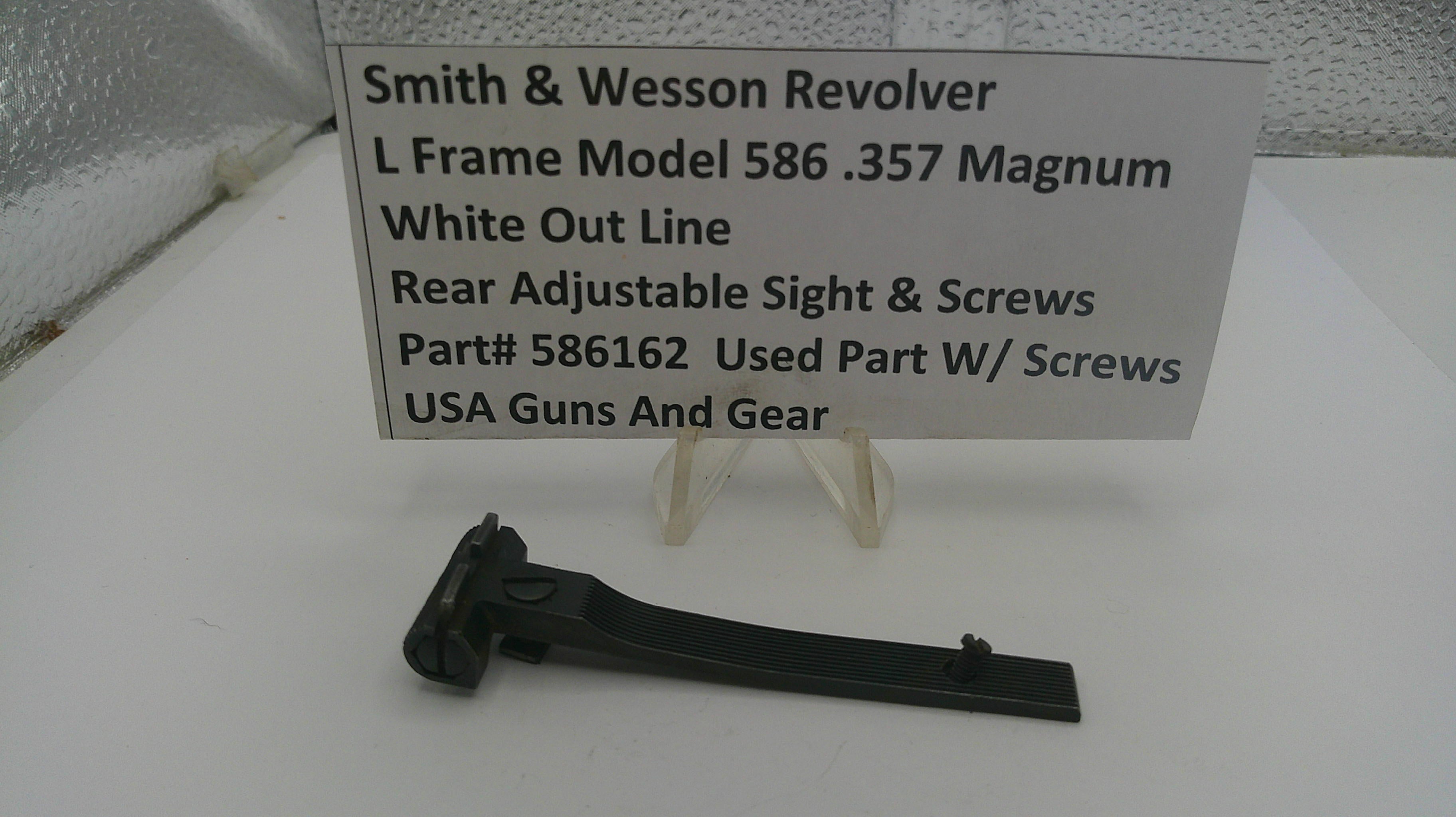 Smith & Wesson revolver part on a white surface with a descriptive sign.