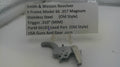 Smith & Wesson revolver trigger part with descriptive label on a white background
