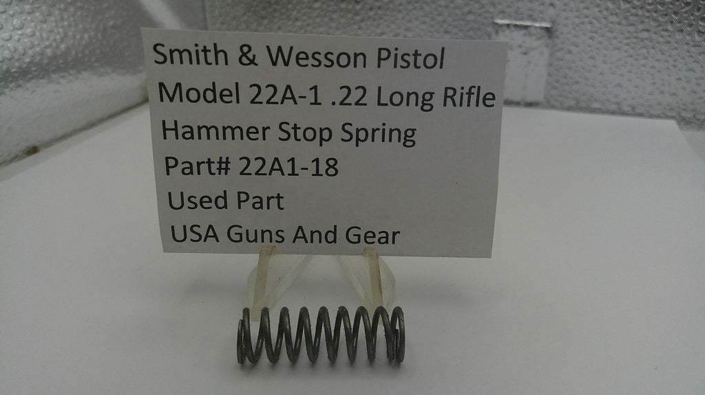 Smith & Wesson pistol part with a label on a white background