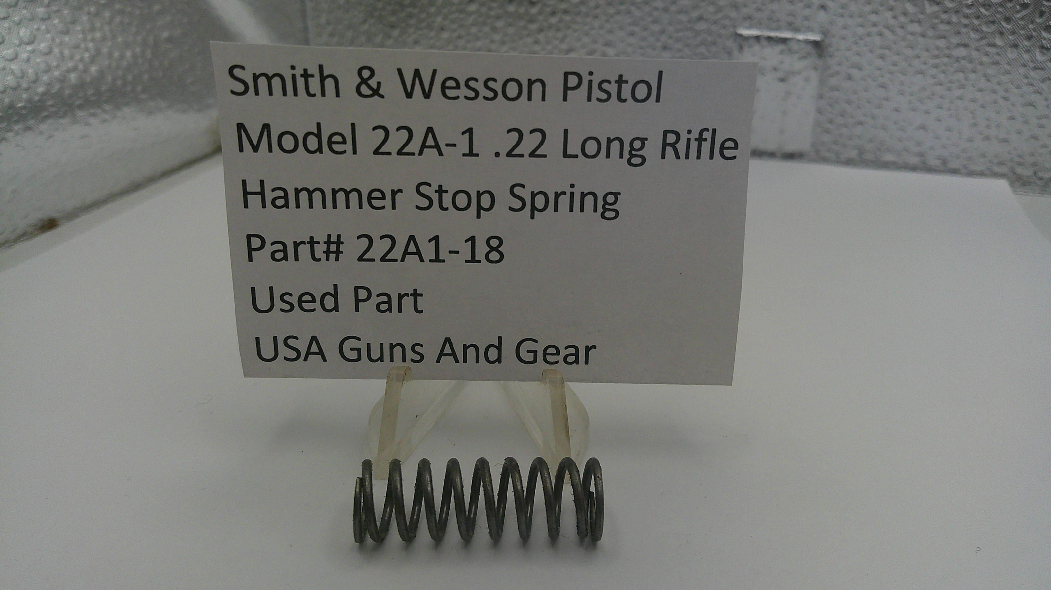 Smith & Wesson pistol part with a label on a white background