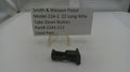 Smith & Wesson pistol take down button part on a white surface with a label.