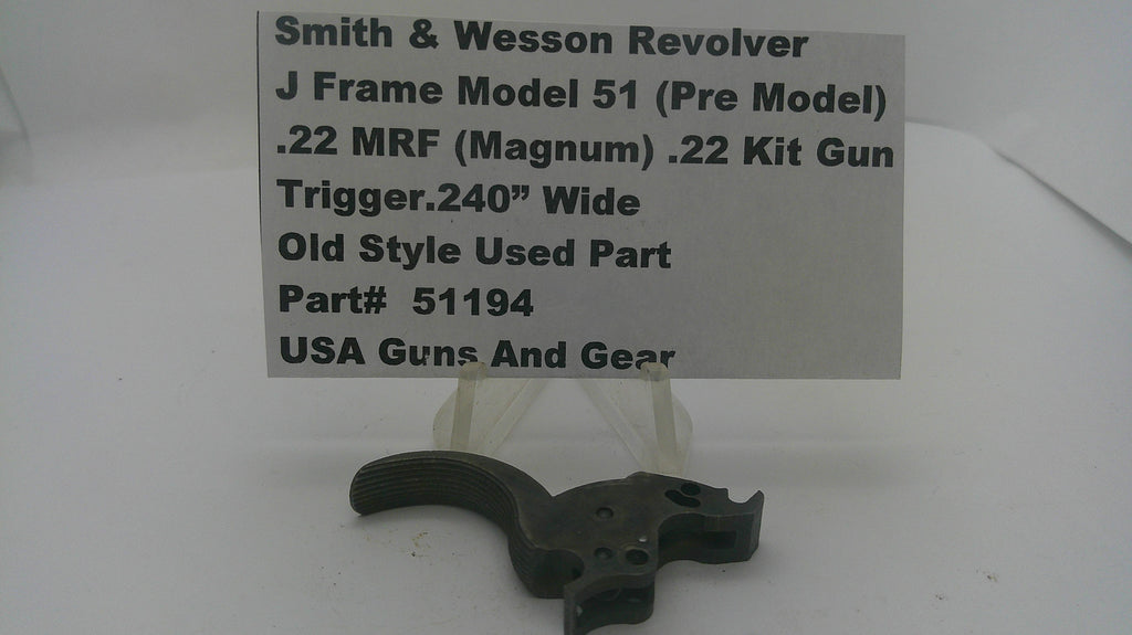 A used black metal Smith & Wesson revolver trigger component displayed on a clear plastic stand with a white paper label card. The label reads 'Smith & Wesson Revolver J Frame Model 51 (Pre Model) .