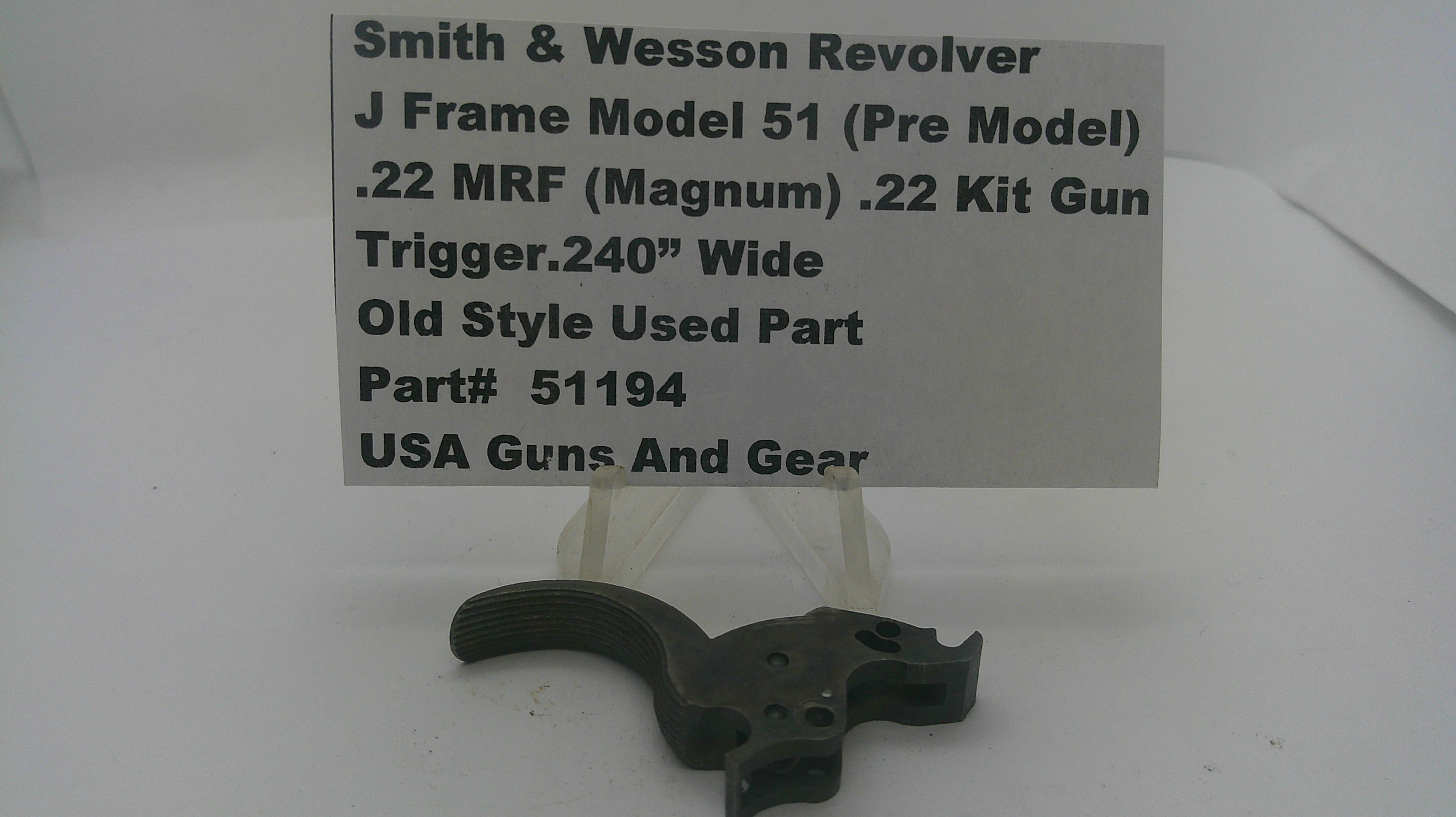 A used black metal Smith & Wesson revolver trigger component displayed on a clear plastic stand with a white paper label card. The label reads 'Smith & Wesson Revolver J Frame Model 51 (Pre Model) .