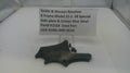 Smith & Wesson revolver part on a white surface with a label