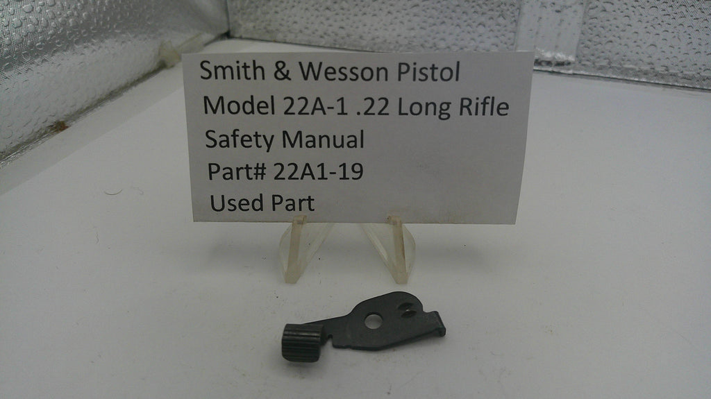 Smith & Wesson pistol safety manual part on a stand with a label