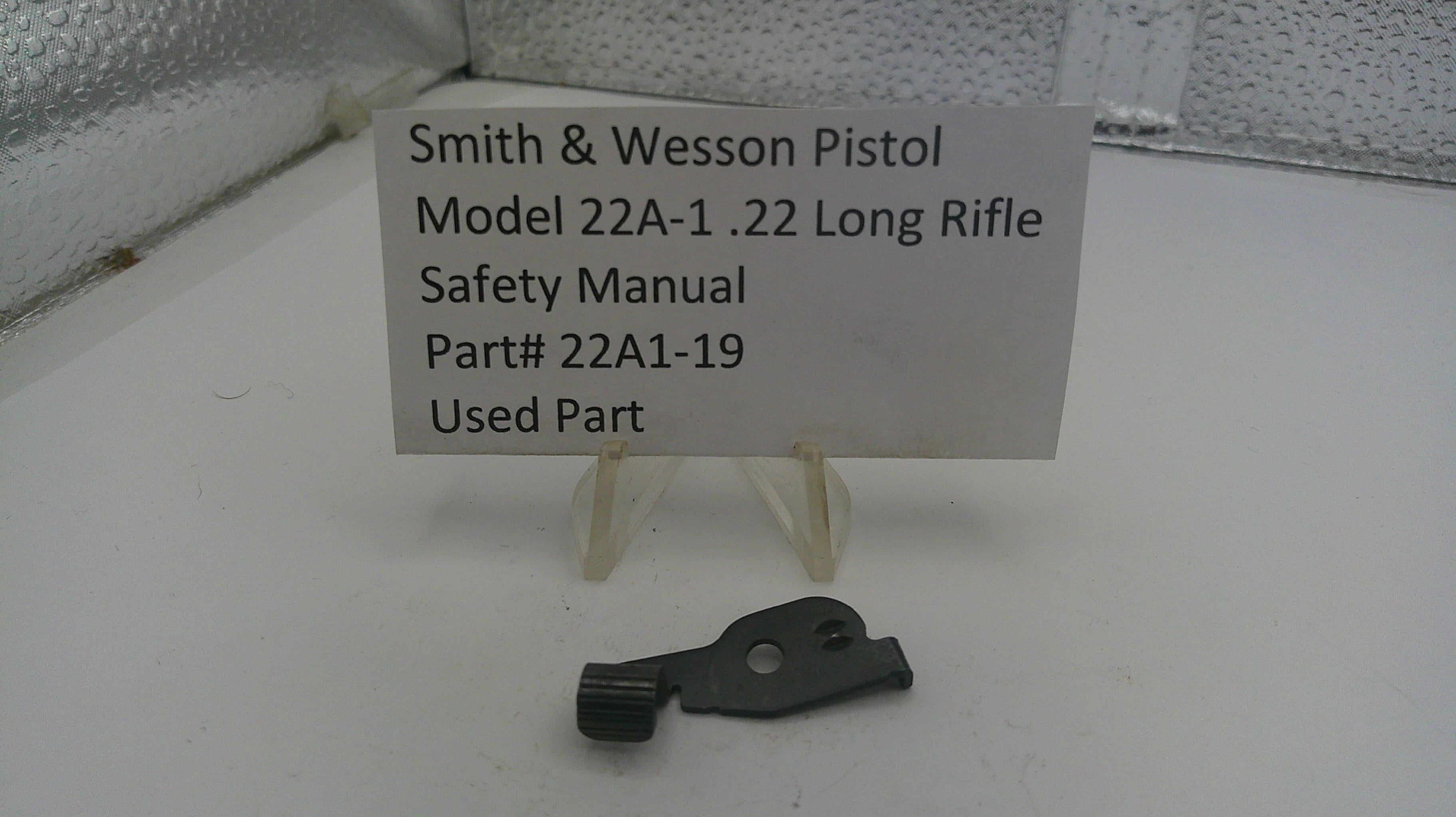 Smith & Wesson pistol safety manual part on a stand with a label