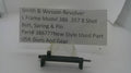 A used black metal Smith & Wesson revolver bolt, spring, and pin part, displayed on a small clear stand with a paper label card behind it on a white background.