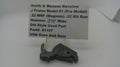 A used metal firearm part displayed on a small stand in front of a white sign that reads 'Smith & Wesson Revolver J Frame Model 51 (Pre Model) .22 MRF (Magnum) .