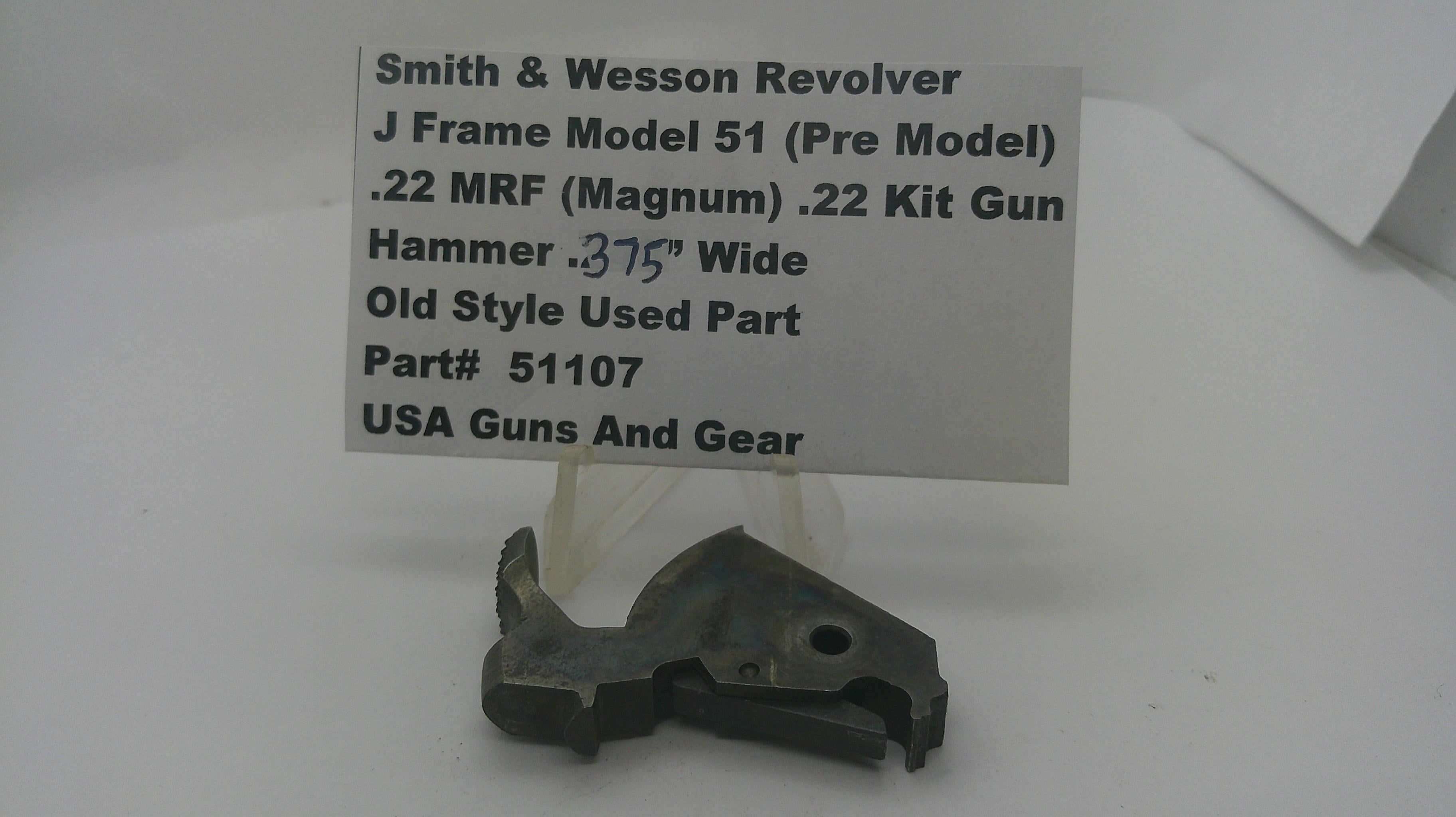 A used metal firearm part displayed on a small stand in front of a white sign that reads 'Smith & Wesson Revolver J Frame Model 51 (Pre Model) .22 MRF (Magnum) .